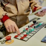 Close-up of worker operating automated machine for wood processi