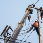 selective-focus-electricians-are-fixing-power-transmission-line-electricity-pole